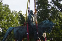 Workers prepare to remove the monument of Confederate General Robert E. Lee on Saturday, July 10, 2021 in Charlottesville, Va.   The removal of the Lee statue follows years of contention, community anguish and legal fights. (AP Photo/John C. Clark)