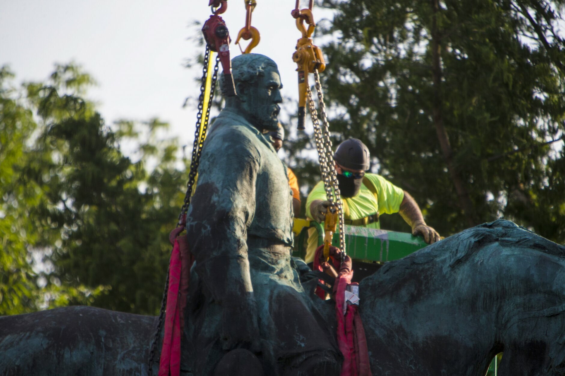 Workers prepare to remove the monuments of Confederate General Robert E. Lee on Saturday, July 10, 2021 in Charlottesville, Va.   The removal of the Lee statue follows years of contention, community anguish and legal fights. (AP Photo/John C. Clark)