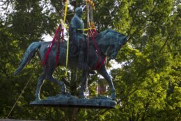 Workers remove the monument of Confederate General Robert E. Lee on Saturday, July 10, 2021 in Charlottesville, Va.   The removal of the Lee statue follows years of contention, community anguish and legal fights. (AP Photo/John C. Clark)