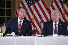 President-elect Donald Trump listens as Virginia Gov. Glenn Youngkin speaks